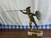 Full view of brass Leonidas statue with spear and shield on marble base