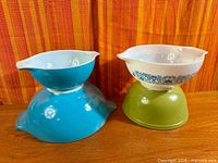All four Pyrex bowls stacked in two pairs showing colors and styles