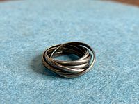 Full view of intertwined sterling silver rolling ring
