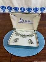 Necklace and earrings displayed in open Elegance box