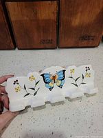 Front view showing full rack, butterfly motif, four hooks