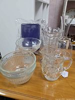 Group shot of all seven clear glass pieces on tabletop