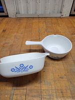 Round handled saucepan and square casserole side by side