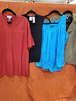 All four tops hanging side by side