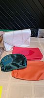 Group shot of four cosmetic bags displayed on table