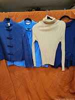 Four tops hanging side by side showing overall colors and styles