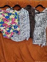 four tops hanging, full view of lot