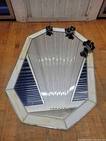 Full view of octagonal mirror showing stained glass border and rose accents