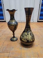 Both brass vases side by side on floor