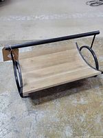 Angled view showing full basket, wood base, metal frame and handle