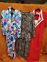 Three vintage dresses hanging side by side