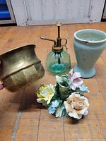 Group shot showing brass planter, glass mister, ceramic vase, porcelain floral figurine