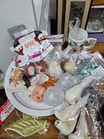 Overview of assorted ornaments in platter with Santa figure and mug