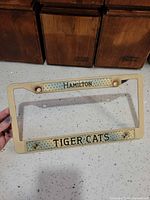 Front view showing Hamilton and Tiger-Cats text and overall discoloration