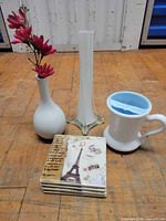 Group shot of all items: two vases, moustache mug, stacked coasters