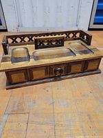 Full view of wood desk organizer showing top trays and lattice gallery