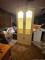 Front view of cream display cabinet with doors closed