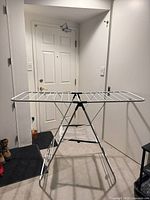 Drying rack fully expanded showing top grid, frame, mesh pouch