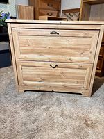 Front view of pine veneer dresser showing two visible drawers and overall style
