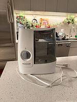 Front view of Honeywell humidifier showing dial, tank and cord