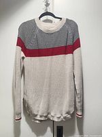 Front view of cream knit Roots Cabin sweater with red stripe and micro-stripe yoke