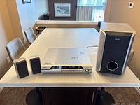 Full view of receiver, two satellite speakers and subwoofer on tabletop