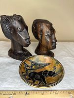 Front view of both busts and elephant dish
