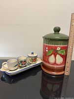 Group view of biscotti jar, tray, sugar pot, and two espresso cups