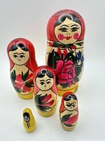 Front view of all five nesting dolls showing sizes and floral paint