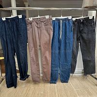 Four pairs of women’s pants on rack