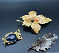 All three brooches front view on black background