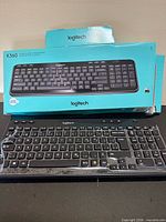 Front view of Logitech K360 keyboard with box