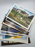 Stack of assorted color travel postcards fanned to show variety