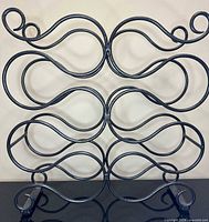 Front view showing full scrollwork design of metal wine rack