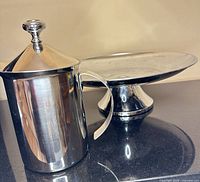 Milk frother and cake stand side by side showing size and finish