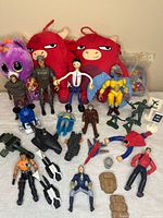Overview of entire mixed toy lot on table