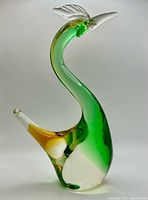 full view of the handblown green and amber glass swan sculpture