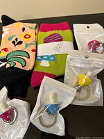 All items: two pairs of novelty socks and four packaged mushroom keychains displayed on a black surface