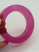 Full view of translucent pink lucite bangle