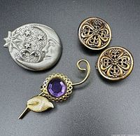 Front view of brooches and clip-on earrings