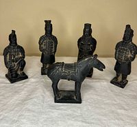 front view of five terracotta-style figurines