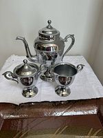 Teapot, sugar bowl with lid, and creamer displayed together
