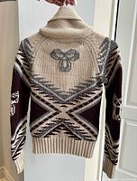 Back view showing large central motif and sleeve patterns