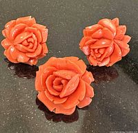 Front view of rose motif earrings and pin