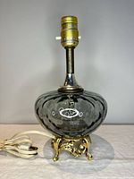 Full view of smoked glass table lamp on gilt base