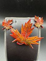 Front view of brooch and earrings on display pad