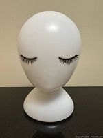 Front view showing full mannequin head and base