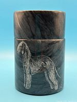 Full view of lidded marble canister showing dog etching