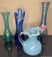 Group shot of all four glass pieces displaying colors, shapes and condition