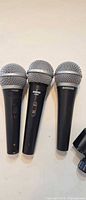 Three Shure microphones side by side showing overall condition